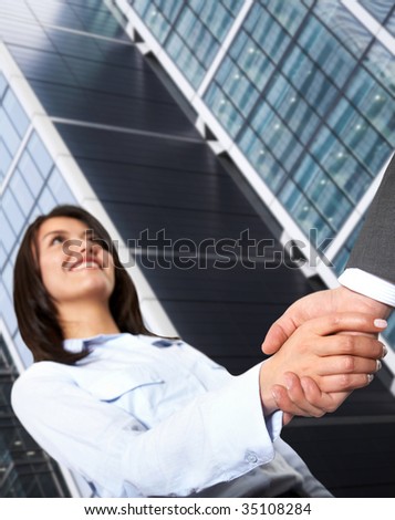 business woman handshaking with a man outdoors
