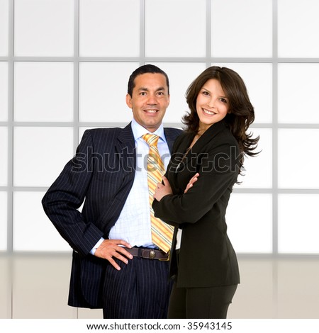 beautiful business couple at an office smiling