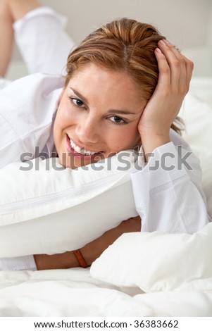Lazy woman in bed hugging a pillow