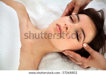 Beautiful relaxed woman getting a facial treatment