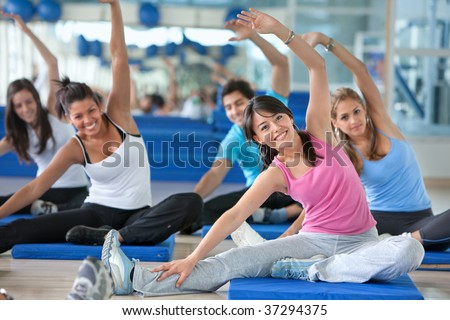 Group of people in a stretching class at the gym