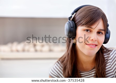 Young Woman portrait with headphones and smiling
