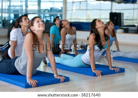 people ath the gym in a stretching class