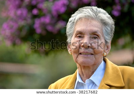 portrait of and elderly woman outdoors smiling
