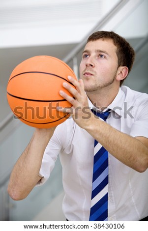 Handsome business man ready to throw a basketball