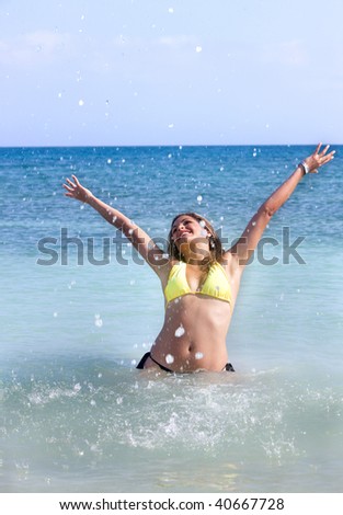 freedom woman with arms up having fun at the beach