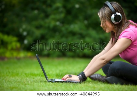 Casual student listening to music on the computer while studying