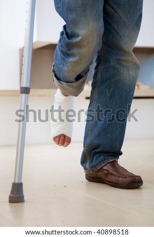 Man with a cast on his leg and crutches