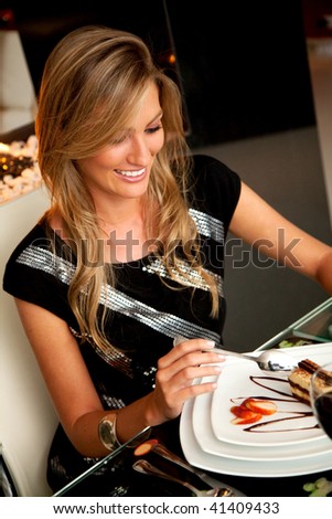 Woman at a restaurant eating a chocolate dessert