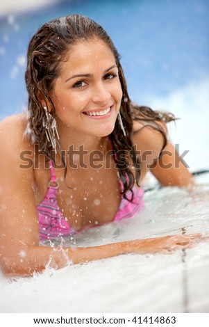 Woman in bikini smiling at the swimming pool