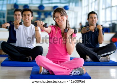 Gym people at an aerobics class with free weights