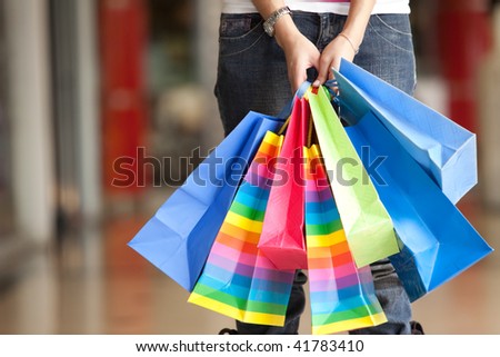 Casual woman carrying shopping bags in a mall