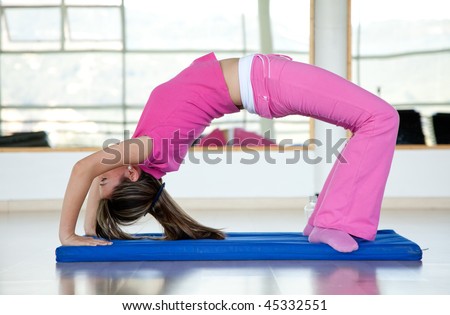 Woman at the gym arching her back on a mat