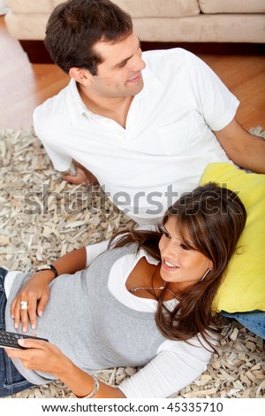 stock photo : Beautiful casual couple at home looking happy
