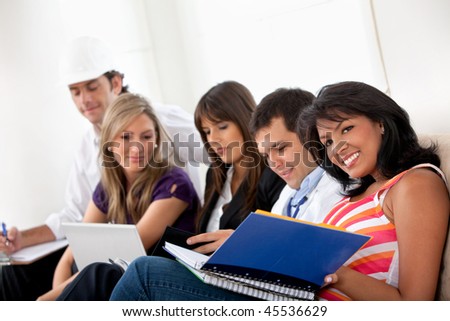 Group of happy people with different professions sitting on a sofa