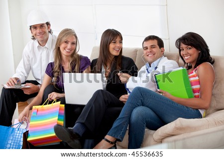 Group of happy people with different professions sitting on a sofa