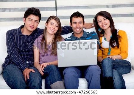 Casual group sitting on the sofa with a laptop