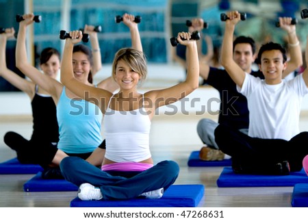 Group of people exercising at the gym with freeweights