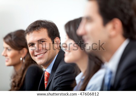 Friendly business man smiling in his office during a meeting
