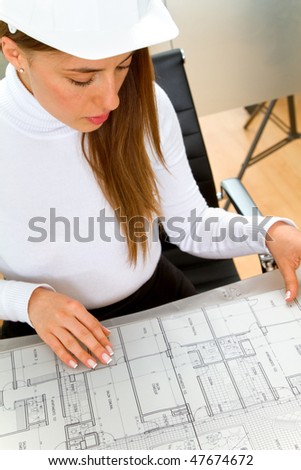female engineer holding a model in an office