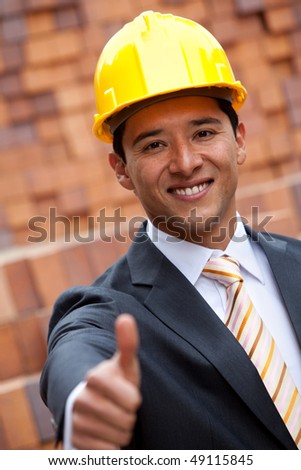 Engineer with thumbs-up at a construction site