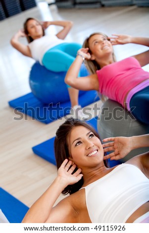 Beautiful group of women at a pilates class at the gym