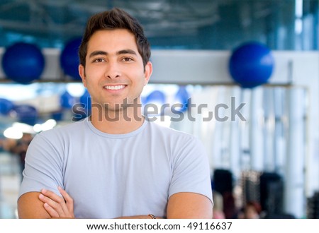 Handsome man portrait at the gym smiling