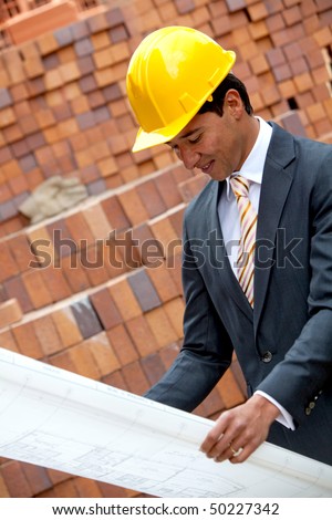 Elegant engineer holding a model in a construction