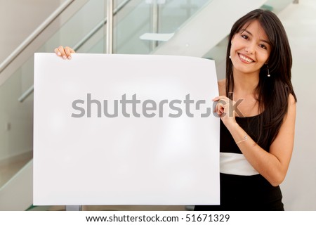 Business woman holding banner ad in her office