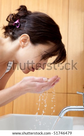 Beautiful portrait of a girl washing her face - Beauty concepts