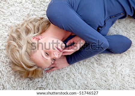 Beautiful woman lying on the floor at home