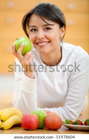 Healthy eating woman smiling and holding an apple on her hand