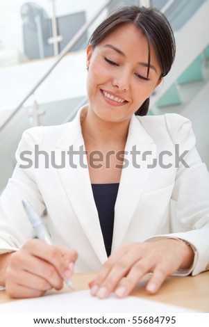Business woman signing a contract at the office