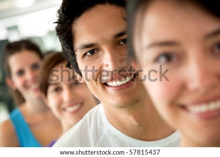 group of people at the gym in a row and smiling