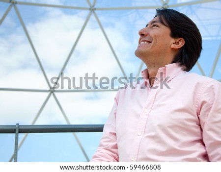 Thoughtful man looking at the sky and smiling in a dome