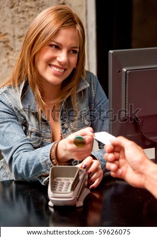 Customer at the till paying by debit or credit card