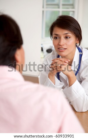 Doctor listening to a patient at her practice