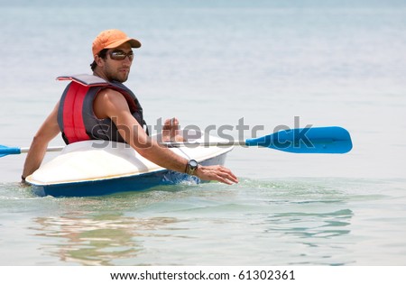 Man in a kayak on the ocean enjoying his holidays