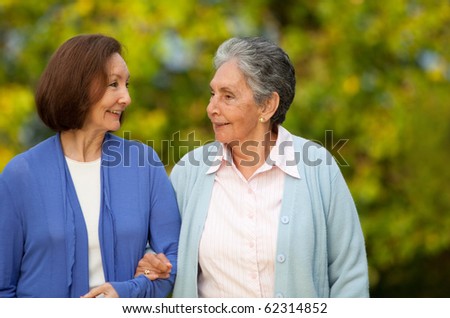 Portrait of an elder mother and daughter walking outdoors
