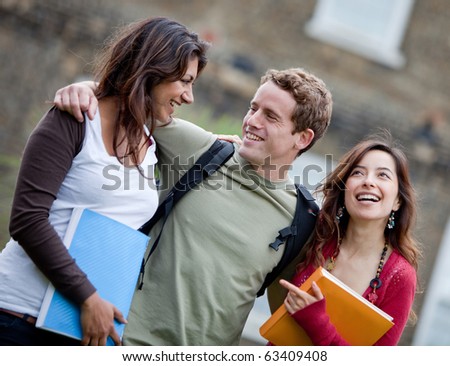 Happy group of students smiling outdoors with notebooks