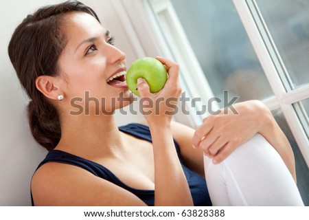 Healthy eating woman biting a green apple