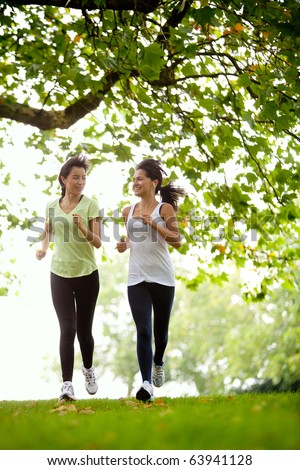 Happy women jogging at the park fitness concepts Happy women jogging at the park fitness concepts