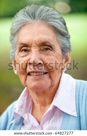 Portrait of a lovely old woman smiling outdoors