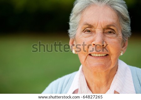 Portrait of a lovely elder woman smiling outdoors