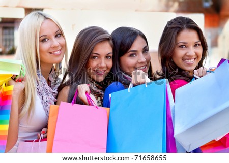 Group of beautiful shopping women with bags and smiling