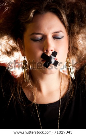 Silenced eccentric woman with tape over her mouth