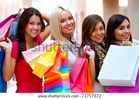 Group of beautiful shopping women with bags and smiling