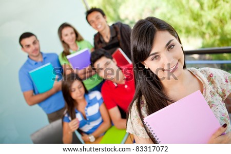 Female student at the university with a group of people behind