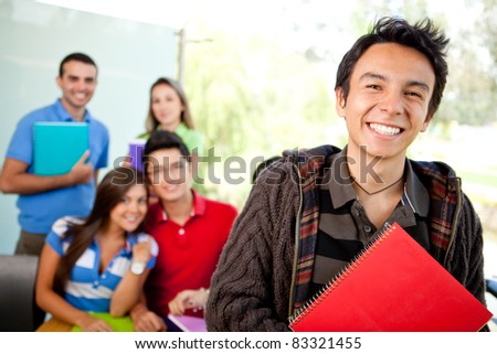 Male student at the university with a group of people behind