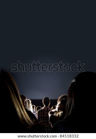 Group of people looking at the screen at the cinema